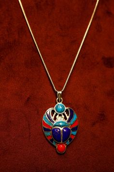 Discover the allure of ancient mysticism with our handcrafted Scarab Beetle pendant necklace, made from exquisite sterling silver. The Scarab Beetle, a symbol of transformation and protection in ancient Egyptian culture, is meticulously designed to capture its intricate details and powerful significance. This necklace is not just a stunning piece of jewelry but also a meaningful talisman that embodies resilience and positive change. Embrace the mystical charm of the Scarab Beetle and carry its timeless symbolism with you wherever you go. Jewel Scarab Beetle, Spiritual Pendant Necklace With Inlay, Scarab Beetle Earrings, Scarab Beetle Necklace, Winged Scarab Necklace, Beetle Necklace, Beetle Pendant, Scarab Beetle, Egyptian Culture