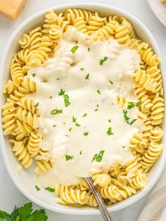 a white bowl filled with pasta and sauce