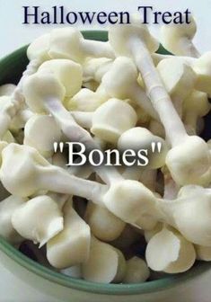 a bowl filled with bone bones on top of a white tablecloth next to the words halloween treat