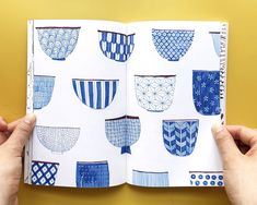 an open notebook with blue and white designs on it