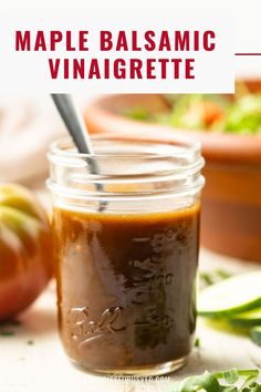 a mason jar filled with homemade balsamic vinaigrete next to some vegetables