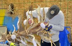 a man is working on some fake antlers