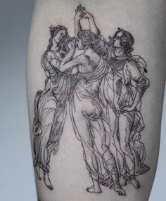 a tattoo on the leg of a woman with three women holding an object in her hand