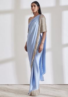 Our noor fringe sari features a full pre-draped sari that looks like a regular sari with our signature fringe detail. Pair it with the off shoulder fringe top or get in touch for more blouse options. Designer Pre-draped Saree With Tassels, Festive Silk Dupatta With Tassels, Traditional Blouse With Tassels For Festive Occasions, Bollywood Saree With Tassels For Wedding, Traditional Festive Blouse With Tassels, Festive Traditional Blouse With Tassels, Wedding Saree With Tassels, Bollywood Blouse Piece With Tassels In Traditional Drape, Bollywood Blouse Piece With Traditional Drape And Tassels