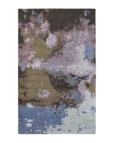 an abstract rug with blue, purple and green colors on the bottom half of it