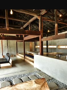 the interior of a building with stone flooring and wood beams on the ceiling is shown