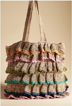 a handbag made out of crocheted yarn with multicolored ruffles