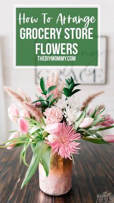 a vase filled with flowers sitting on top of a wooden table next to a sign that says how to arrange grocery store flowers