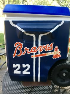 a cooler sitting on top of a metal table