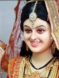 a close up of a person wearing a head piece and jewelry on her face, smiling at the camera