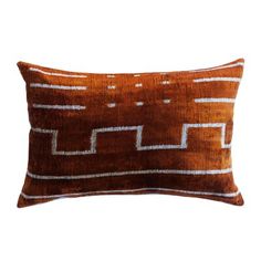 an orange and white pillow with lines on the front, sitting on a white background