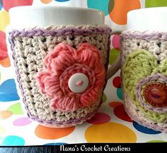 two crocheted coffee mugs with flowers on them