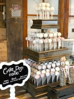 there is a cake pop display on the table