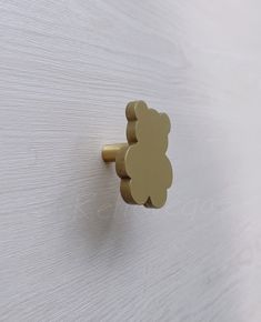 a close up of a door handle with a teddy bear design on it's side