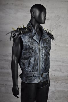 Step into the spotlight with our Rebel Edge Spiked Leather Vest, a statement piece designed for the bold and the brave. Crafted from hand-painted leather and adorned with hand-placed metal studs, this vest embodies the spirit of rebellion. The shoulder tassels, made from upcycled bicycle inner tubes and decorated with authentic bicycle valves, add an eco-friendly twist to your punk-rock look. Perfect for those who ride against the wind, this vest is your armor in the urban jungle. Strap on your Dystopian Costume, Shoulder Tassels, Rocker Costume, Post Apocalyptic Clothing, Heavy Metal Style, Apocalyptic Clothing, Heavy Metal Fashion, Rock Outfit, Rock Outfits