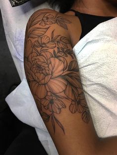 a woman with a flower tattoo on her arm