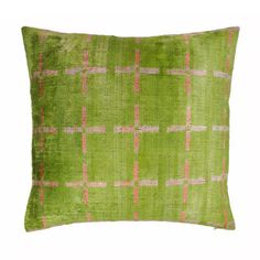 a green pillow with pink and white squares on the front, against a white background