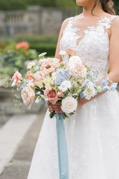 a woman in a wedding dress holding a bouquet