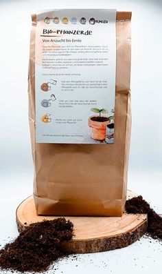 a bag of soil sitting on top of a piece of wood