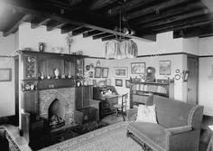 an old fashioned living room with fireplace and furniture in black and white photo - stock image