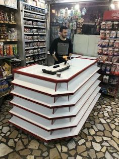 a man standing behind a counter in a store