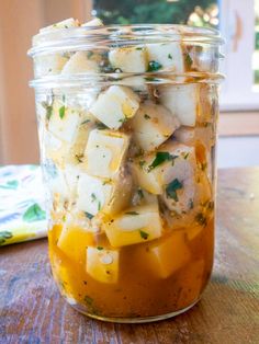 a jar filled with food sitting on top of a wooden table