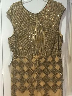 a gold dress hanging on a door