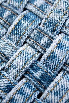 close up view of blue jeans woven in the form of an abstract basket or weave