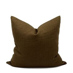 a brown pillow sitting on top of a white wall