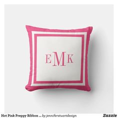 a pink and white pillow with the letter e m k on it's side