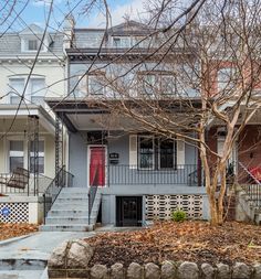 two story house with red door and stairs