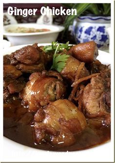 a white plate topped with meat covered in gravy