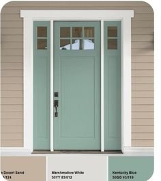 a green front door with white trim and two lights on the side of a house