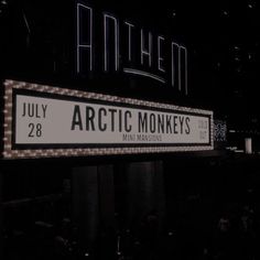 a sign that is lit up in the dark for an arctic monkeys show on july 28