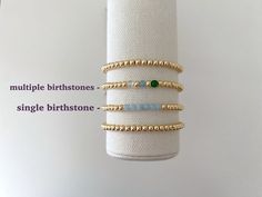 one 14k gold plated stacking bracelet with your choice of birthstone bead added January | garnet February | amethyst March | aquamarine April | clear quartz May | emerald June | pearl July | Ruby August | peridot September | sapphire October | pink tourmaline November | citrine December | turquoise bracelets are made on a durable stretch elastic cord please refer to our sizing guide before purchasing 14k Gold Filled Yellow Gold Bracelets With Birthstone, Dainty Stackable Beaded Bracelets As Gift, Anniversary Jewelry With Round Birthstone Beads, Gold Birthstone Bracelet In 14k Gold Filled, Stackable 14k Gold Filled Bracelets As A Gift, Everyday Round Beads Birthstone Bracelets, Adjustable Everyday Jewelry With May Birthstone, Dainty Stackable Beaded Bracelets For Gifts, Dainty Beaded Bracelets For Birthday