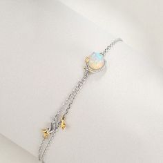 Great for both everyday ensembles and special outings, this Opal Bracelet features a man-made opal stone on a dainty silver chain with pops of gold. The outstanding opal stone glimmers with hints of blue and baby pink. 
 Product ID: JW5456 
 Includes: 1 bracelet 
 Material: 925 silver, man-made opal 
 Chain Length: 7.3  
 Uses: Bracelet, jewelry, accessories, fashion, style, etc. www.ccovv.com Rose Pale, Apollo Box, Opal Bracelet, Unique Bracelets, Opal Stone, Accessories Fashion, Bracelet Jewelry, Silver Man, Chain Lengths