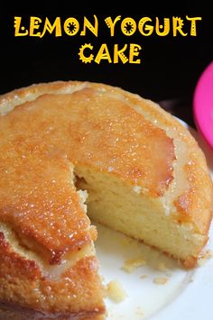 a lemon yogurt cake on a plate with a piece missing from the cake