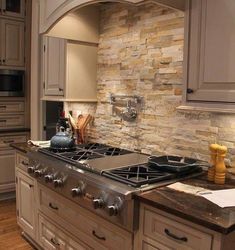 a stove top oven sitting inside of a kitchen next to a sink and countertop