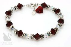 a bracelet with red glass beads and heart charms