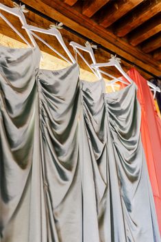 there are many different colored dresses hanging on the rack