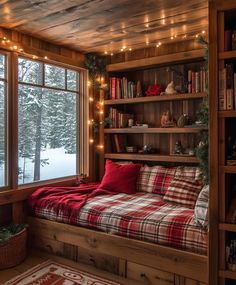 a bed in a room with lots of books on the shelves and lights hanging from the ceiling