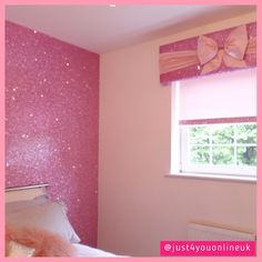 a bedroom with pink glitter wallpaper and bow tie valance on the window sill