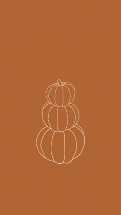 a stack of pumpkins sitting on top of each other in front of a brown background