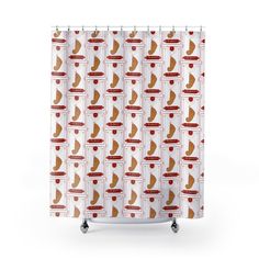 a shower curtain with red and white designs on it