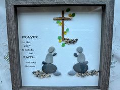 two rocks in a frame with a cross on the top and words above them that read, prayer is the key to heaven but faith