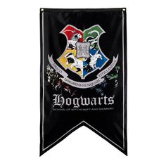 a harry potter flag hanging from the side of a white wall with hogwart's crest on it