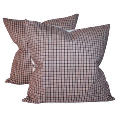 two brown and white checkered pillows on a white background