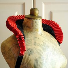 a mannequin with red and black ruffles on it's neck