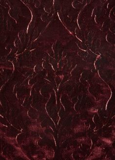 an image of a red velvet textured material with intricate designs on it's surface