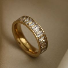 a gold wedding band with baguetts of diamonds